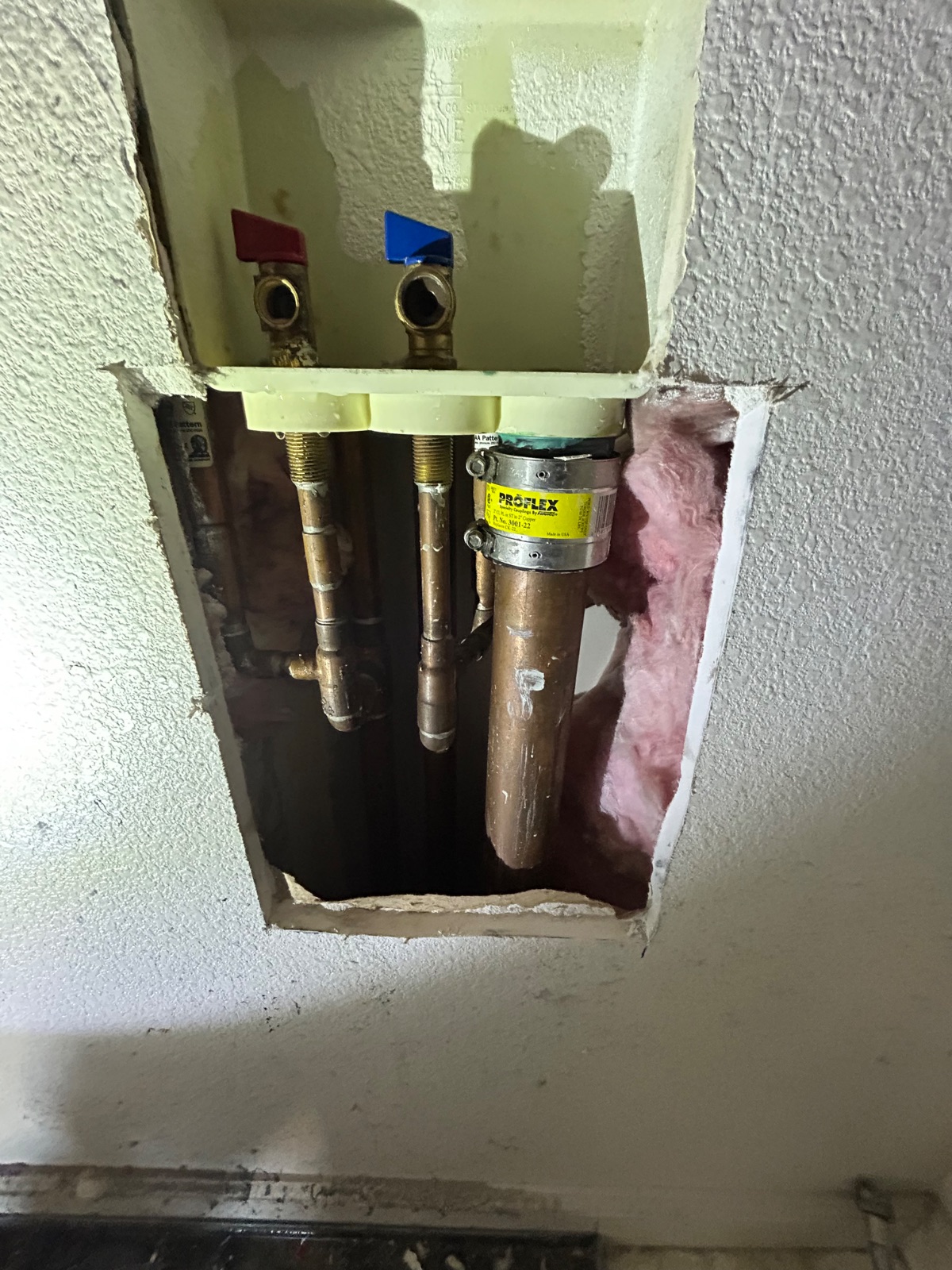 Old laundry box and supply lines before replacement